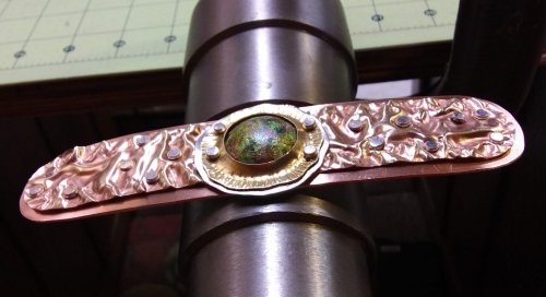 Judy Larson's Fold Formed Cuff With Faux Roman Glass or Coin Cabochon - , Metalwork, Cutting, Cutting Tool, Cutters, Dapping, Dapping Jewelry, Filing, Finishing, Forging, Forging Jewelry, Jewelry Forging, How To Punch Holes, Hole Punching, Punch A Hole, Oxidizing Wire, Oxidizing, Antiquing Wire, Antiquing, Riveting, Riveting Techniques, Wire Rivets, Sawing, Saw, Wire Saw, Texturing, Drilling, Drill, Fold Formed Faux Roman Glass Cuff